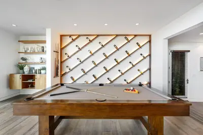 a pool table in a living room with a wall at Franklin Modern in Los Angeles