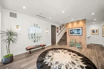 a living room with a staircase and a rug at Willow Glen in Los Angeles