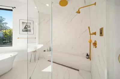 a bathroom with a shower and a tub and a sink at Willow Glen in Los Angeles