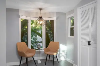 a dining room with two chairs and a window at Hidden Valley PL in Los Angeles
