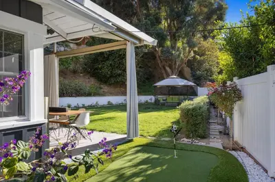 a garden with a white pergola and a lawn at Hidden Valley PL in Los Angeles