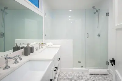 a white bathroom with a tub and a shower at Hidden Valley PL in Los Angeles