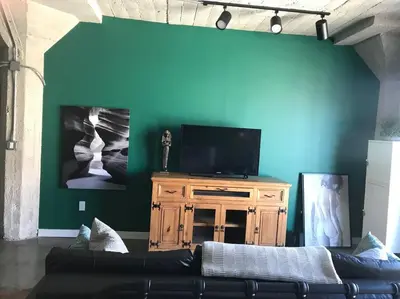 a living room with a couch and a flat screen tv at BO-BOU Suite in Los Angeles