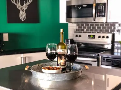 a table with two glasses of wine and a bowl of food at BO-BOU Suite in Los Angeles