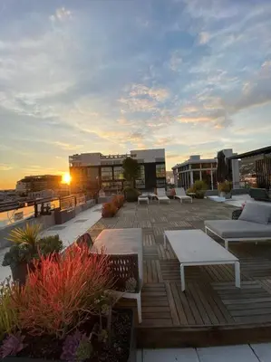 a rooftop patio with tables and benches on a building at BO-BOU Suite in Los Angeles