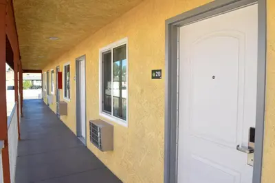 a hallway of a school with a white door at Mojave Inn in Victorville