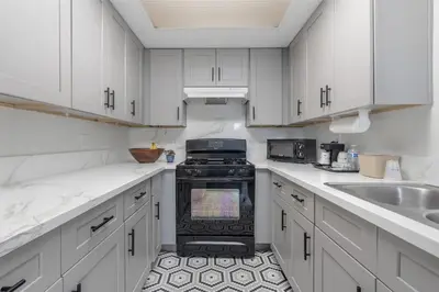 a white kitchen with a stove and a sink at Best Western Westminster Inn in Westminster