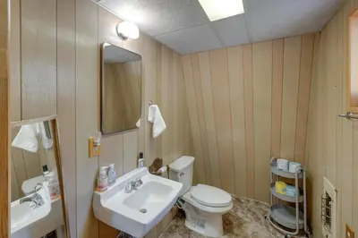a bathroom with a sink and a toilet and a mirror at Quiet Sequoia National Forest Cabin with Fireplace in Posey