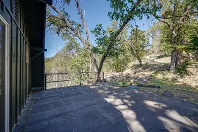 a walkway outside of a house with a tree at Quiet Sequoia National Forest Cabin with Fireplace in Posey