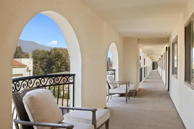 a balcony with chairs and a view of the mountains at Hotel Huntington in Duarte