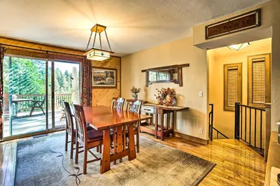 a dining room with a wooden table and chairs at Tranquil Twin Peaks Retreat Hike, Ski and Swim in Twin Peaks