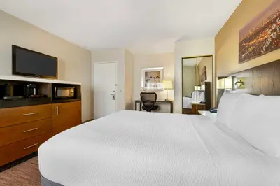 a hotel room with a large bed and a television at Best Western Royal Palace Inn & Suites in Los Angeles