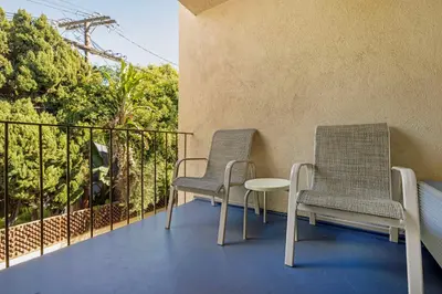 two chairs and a table on a balcony at Best Western Royal Palace Inn & Suites in Los Angeles