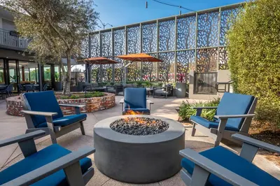 a patio with chairs and a fire pit in front of a building at Olivia Hotel in Los Angeles