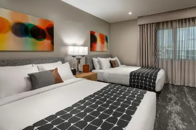 a hotel room with two beds and a window at Olivia Hotel in Los Angeles