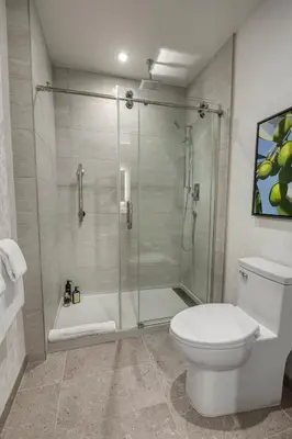 a bathroom with a shower and a toilet at Olivia Hotel in Los Angeles