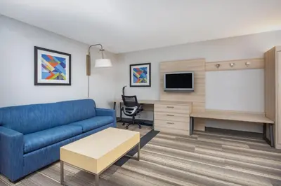 a living room with a couch and a tv at Holiday Inn Express Ontario by IHG in Creekside