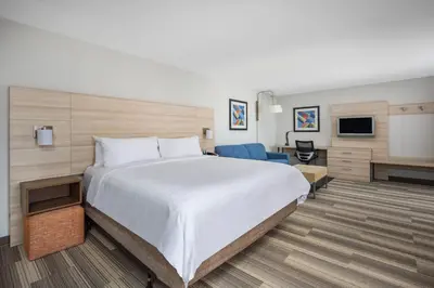 a hotel room with a large bed and a tv at Holiday Inn Express Ontario by IHG in Creekside