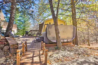 a house with a boat on a wooden deck at Lake Arrowhead Studio Near Hiking with Hot Tub in Lake Arrowhead