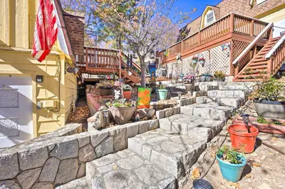a garden with potted plants and a stone wall at Lake Arrowhead Studio Near Hiking with Hot Tub in Lake Arrowhead