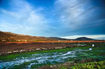 a river in a field with mountains in the background at Holiday Inn Express & Suites Carpinteria by IHG in Carpinteria