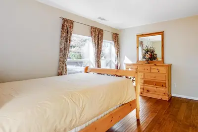 a bedroom with a bed and a dresser and a mirror at Running Springs R-n-R in Running Springs