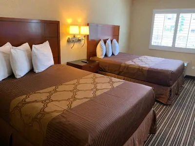 a hotel room with two beds and a window at Buena Park Inn in Anaheim