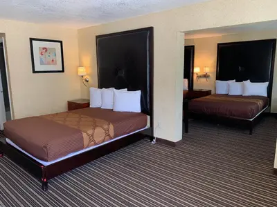 a hotel room with two beds in a room at Buena Park Inn in Anaheim