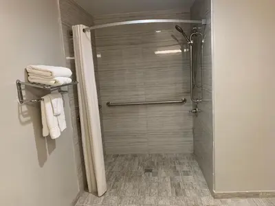 a shower stall with towels in a bathroom at Buena Park Inn in Anaheim