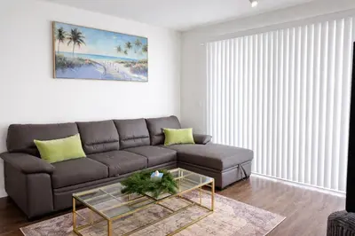 a living room with a couch and a glass table at ViewPoint Suites in Los Angeles
