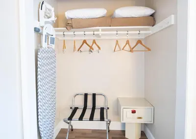 a bedroom with a bunk bed and a chair at Anaheim Islander Inn and suites near Park and Convention center in Anaheim
