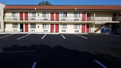 an empty parking lot in front of a building at Royale Inn Motel in Whittier