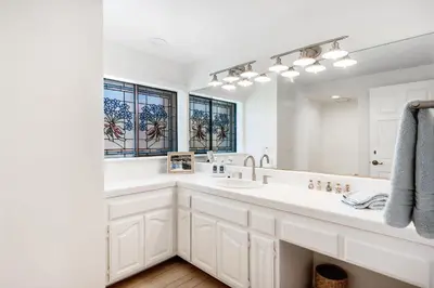 a bathroom with a large sink and a large mirror at Sandcastle by the Sea in Oxnard