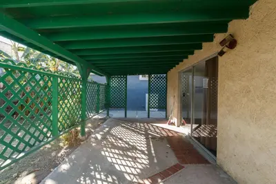 a green porch with a green railing and a building at Los Angeles 3 Bedroom Charmer Large Guest House in Los Angeles