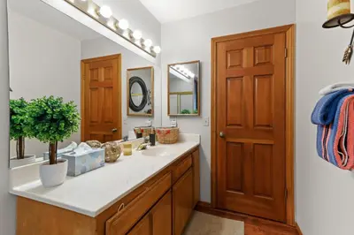 a bathroom with a sink and a mirror at Howard's Cabin in Lake Arrowhead