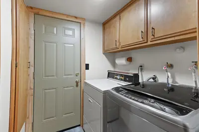 a small kitchen with a sink and a washing machine at Howard's Cabin in Lake Arrowhead