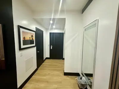 a hallway with two black doors and a mirror at Casa Playa Inn - Stanton, Anaheim in Stanton