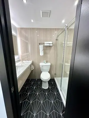 a bathroom with a toilet and a shower at Casa Playa Inn - Stanton, Anaheim in Stanton