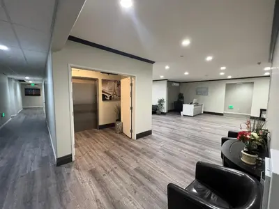 an empty office with a lobby with chairs and desks at ASPIRE INN & SUITES Orange in Orange