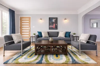 a living room with a couch and two chairs and a table at Modern LA Home Near Museums, Dining & Downtown in Los Angeles