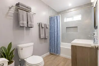 a bathroom with a toilet and a sink and a shower at Modern LA Home Near Museums, Dining & Downtown in Los Angeles