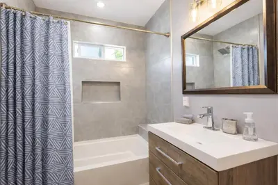 a bathroom with a sink and a tub and a shower at Modern LA Home Near Museums, Dining & Downtown in Los Angeles