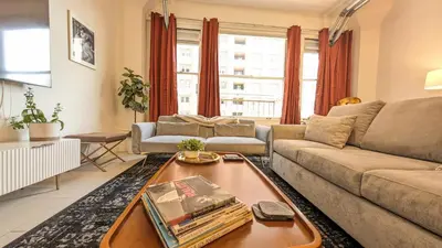 a living room with a couch and a table at Classic Los Angeles Elegance in Downtown, Sleeps 4, Free Parking and 360 Degree View Roof Top Pool! in Los Angeles