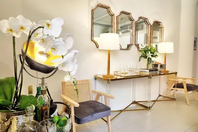 a room with a desk and chairs and mirrors at Classic Los Angeles Elegance in Downtown, Sleeps 4, Free Parking and 360 Degree View Roof Top Pool! in Los Angeles