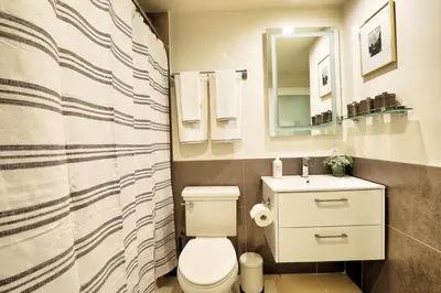 a bathroom with a toilet and a sink at Classic Los Angeles Elegance in Downtown, Sleeps 4, Free Parking and 360 Degree View Roof Top Pool! in Los Angeles