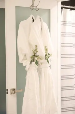 a couple of white wedding dresses hanging on a door at Classic Los Angeles Elegance in Downtown, Sleeps 4, Free Parking and 360 Degree View Roof Top Pool! in Los Angeles