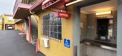 a store with a coffee sign on the side of a building at RUBY MOTEL in Long Beach