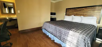 a hotel room with a large bed with white pillows at RUBY MOTEL in Long Beach