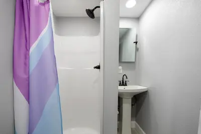 a bathroom with a shower curtain and a sink at Arrowhead Aerie in Lake Arrowhead
