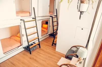 a room with bunk beds and stairs in a tiny house at STAY OPEN Venice Beach in Los Angeles